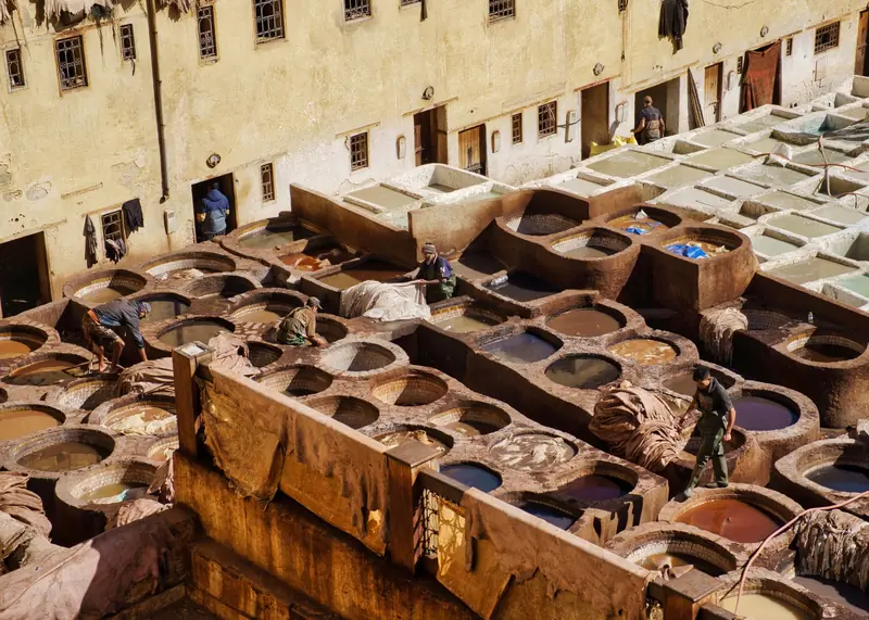 Aerial view of traditional tanneries in Fes, Morocco, showcasing leather dyeing process