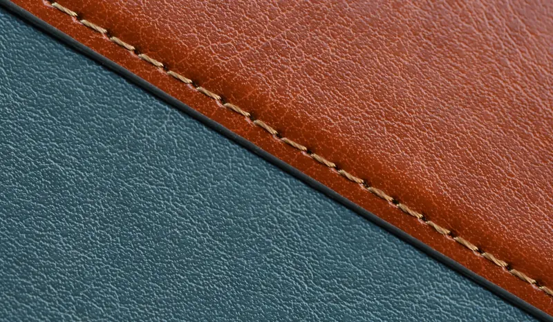 Detailed close-up of brown and blue stitched leather textures, showcasing craftsmanship