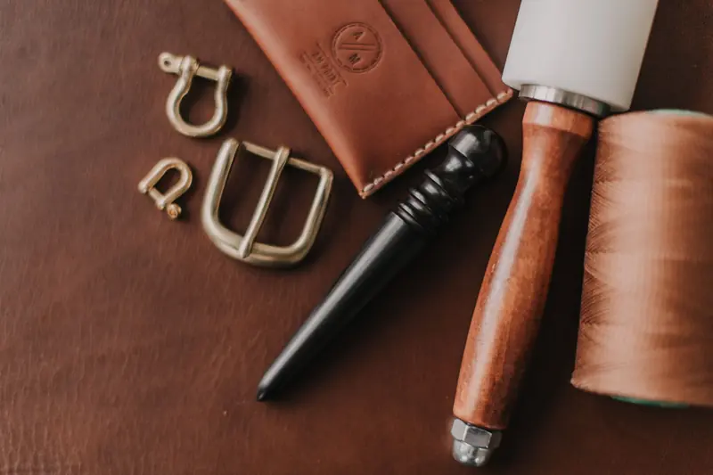 Close-up of leather crafting tools and materials, showcasing handcrafted techniques and equipment