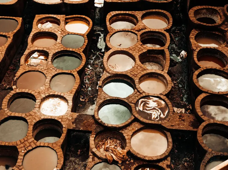 Top view of a traditional Moroccan tannery with circular dye pits for leather processing